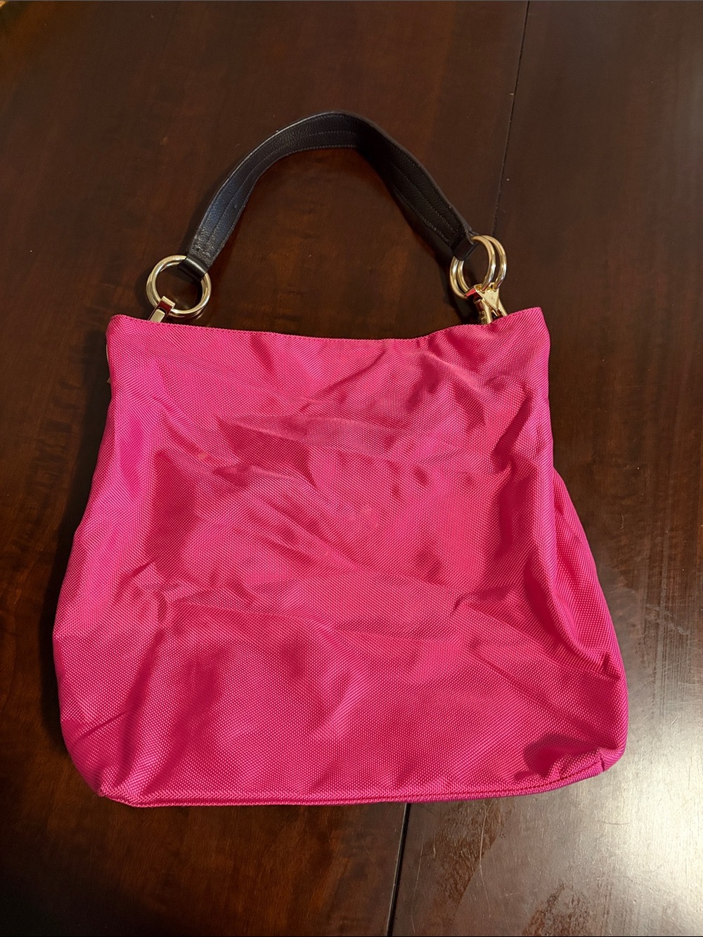 Vibrant Pink Shoulder Tote with Black Top Handle and Gold Rings